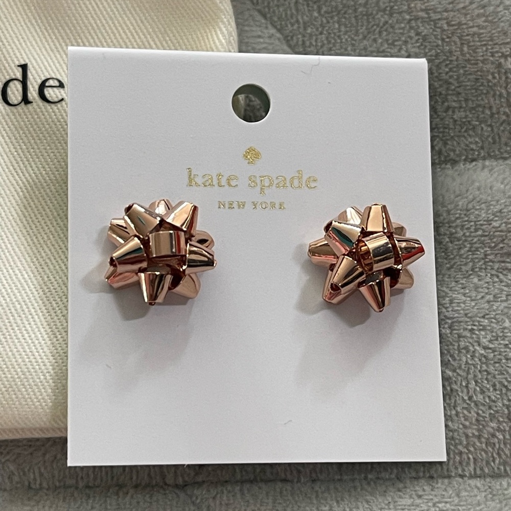 NWT Kate Spade Earrings with dust cover. Bronze bows. Super cute